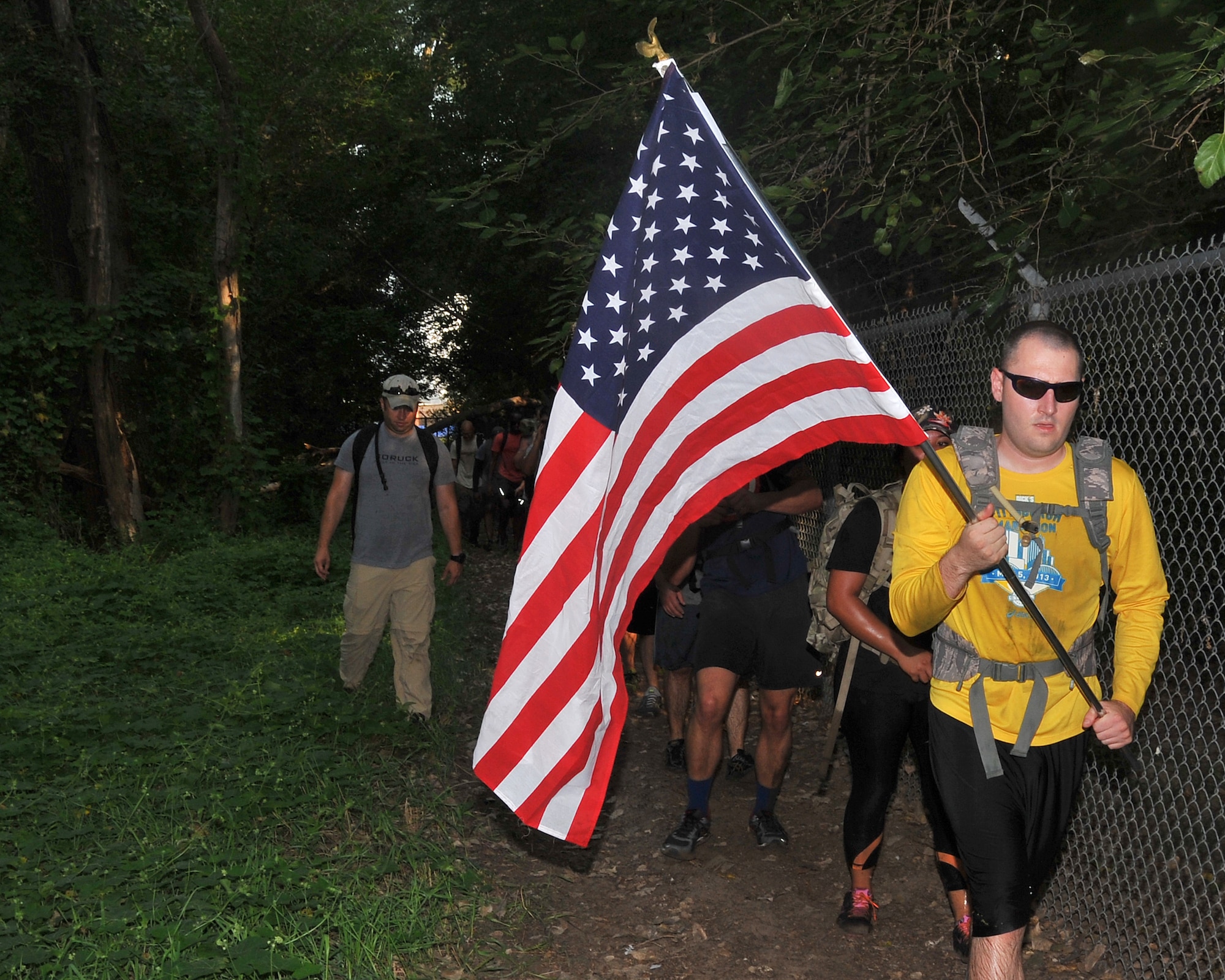 U.S. Air Force Staff Sgt. Adam Oles, Airman Leadership School instructor, carries the U.S. Flag during the Team Cohesion Challenge held on Aug. 22, 2015, at Offutt Air Force Base, Nebraska. The challenge has been held at multiple locations across the country this past summer. (U.S. Air Force photo by D.P. Heard/Released)