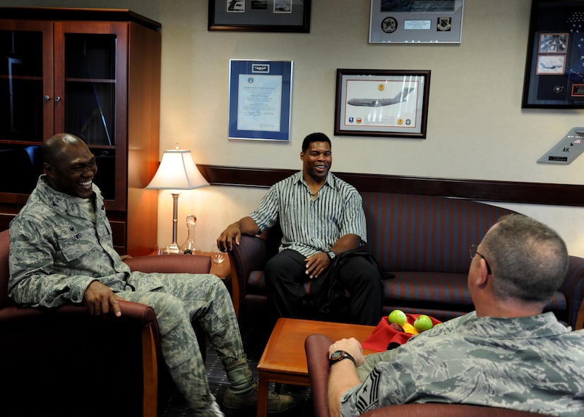 Col. Rodney Lewis, 319th Air Base Wing commander, left, Herschel Walker, center, and Chief Master Sgt. David Duncan, 319th Air Base Wing command chief, right, share stories before making their way to Summer Bash August 20, 2015, on Grand Forks Air Force Base, North Dakota. Walker, a former NFL running back, was the special guest speaker for Summer Bash 2015. Lewis, Duncan and Walker spent the day outdoors with Airmen and their families and even judged some of the events. (U.S. Air Force photo by Airman 1st Class Ryan Sparks/Released)