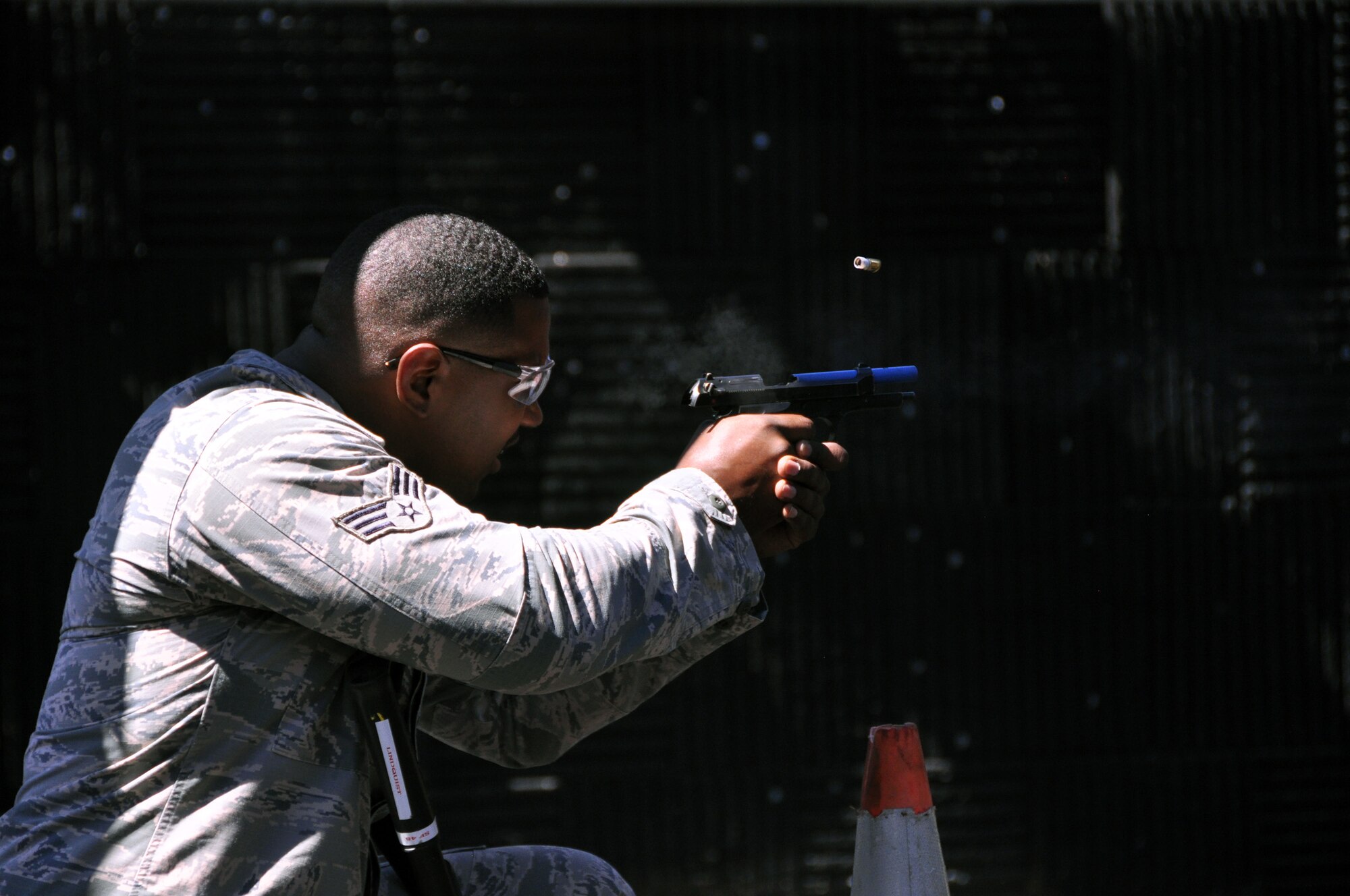 A member of the Security Forces Squadron fires an M-9 pistol as part of a shoot, move and communicate drill held at the firing range in Clinton, Pennsylvania, Aug. 23, 2015. Members were rated on a number of aspects of the exercise, one of them being marksmanship with defenders using both the M-4 rifle and M-9 pistol, firing from distances of 5 to 25 feet. (U.S. Air Force photo by Senior Airman Joseph E. Bridge)
