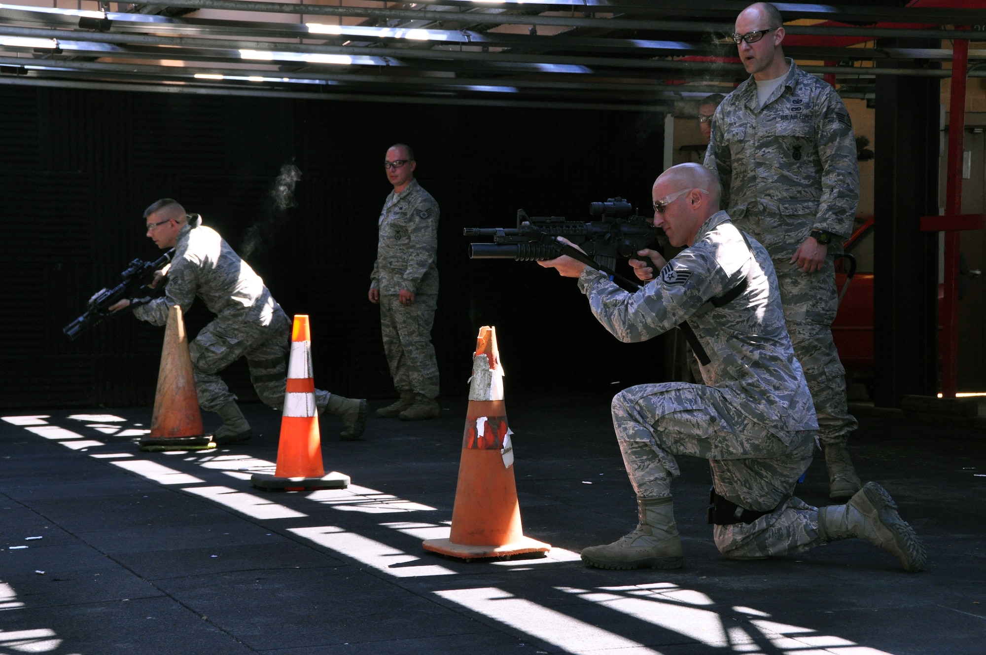 Members of the Security Forces Squadron participate in shoot, move and communicate drills as instructors watch the movement of defenders, the verbal communication between team members and how well they switch from the M-4 rifle to the M-9 pistol, when directed by instructors, at the firing range in Clinton, Pennsylvania, Aug. 22, 2015. The purpose of the exercise is to train defenders on how to communicate effectively, while moving about the battlefield in a safe and effective manner through the use of barricades and tactics. (U.S. Air Force photo by Senior Airman Joseph E. Bridge)