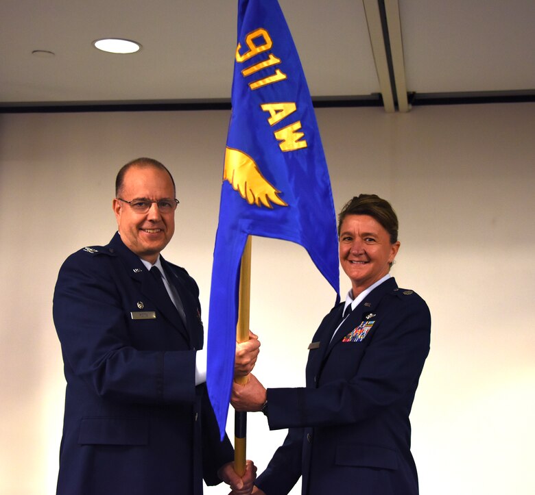 Col. Joseph Potts, 911th Operations Group commander, presents the 911th Aeromedical Evacuation Squadron guidon to Lt. Col. Marsha Schuman at the Pittsburgh International Airport Air Reserve Station, Aug. 23, 2015. The exchange of the guidon represents Schuman’s assumption of command of the 911th AES.  (U.S. Air Force photo by Staff Sgt. Justyne Obeldobel)