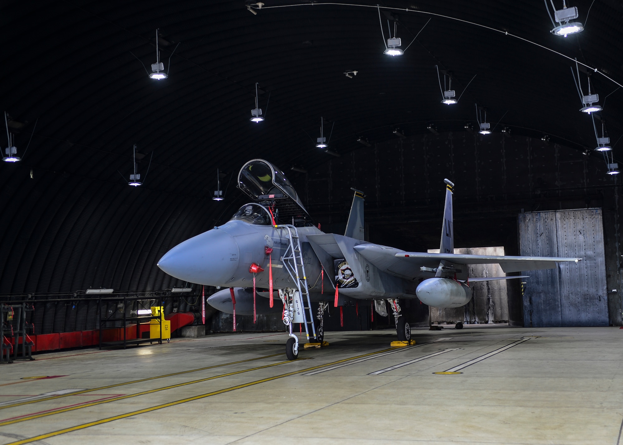 An F-15E Strike Eagle sits under newly-installed light-emitting diode lights at a protective aircraft shelter on Royal Air Force Lakenheath, Aug. 21, 2015. The lights were changed to help reduce the base energy requirement, but there are great mission benefits including no maintenance required. (U.S. Air Force photo by Senior Airman Nigel Sandridge/Released) 