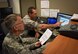 Lt. Col. Stuart Rhoades, the Capstone Inspection Major Graded Area team lead, and Lt. Col. Kristopher Terry, the MGA2 team lead, discuss inspection items listed in the Inspector General Evaluation Management System during a Capstone Inspection at Pittsburgh International Airport Air Reserve Station, Aug. 23, 2015. IGEMS is used to facilitate Air Force-wide trend analysis and reporting, and deficiency resolution. (U.S. Air Force Photo by Staff Sgt. Brandy L. Grace)