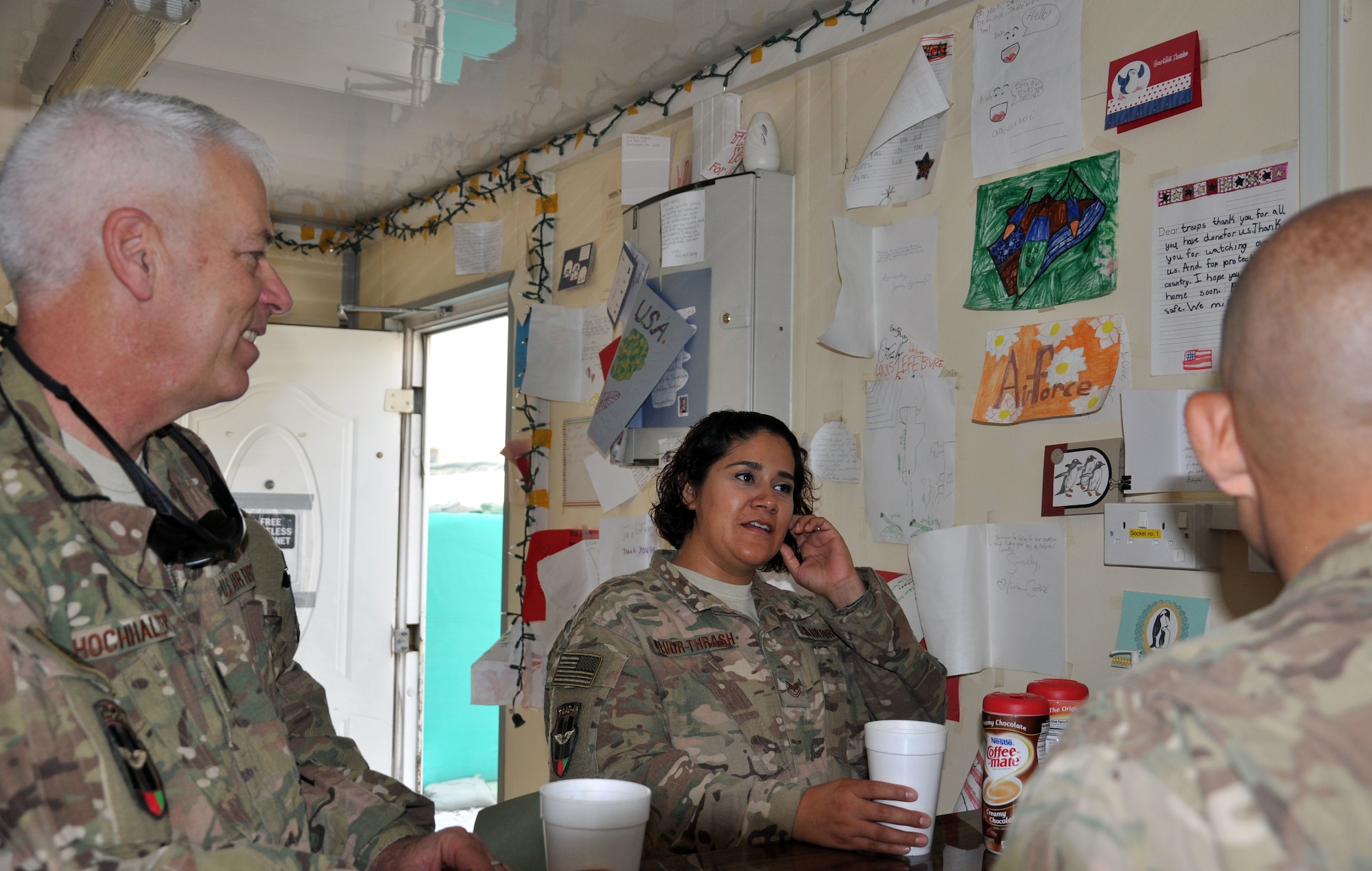 Chaplain (Lt. Col.) Bryan Hochhalter and Tech. Sgt. Sandra Alvor-Thrash talk to Train, Advise, Assist Command-Air (TAAC-Air) personnel in the “Gratitude Café” during their weekly rounds to work centers at Forward Operating Base Oqab, Aug. 16, 2015. Hochhalter is deployed to Kabul, Afghanistan, from the U.S. Air Force Academy in Colorado Springs, Colo. Alvor-Thrash is deployed from Eglin Air Force Base, Fla. (U.S. Air Force photo/Master Sgt. Barbara Fuller)
