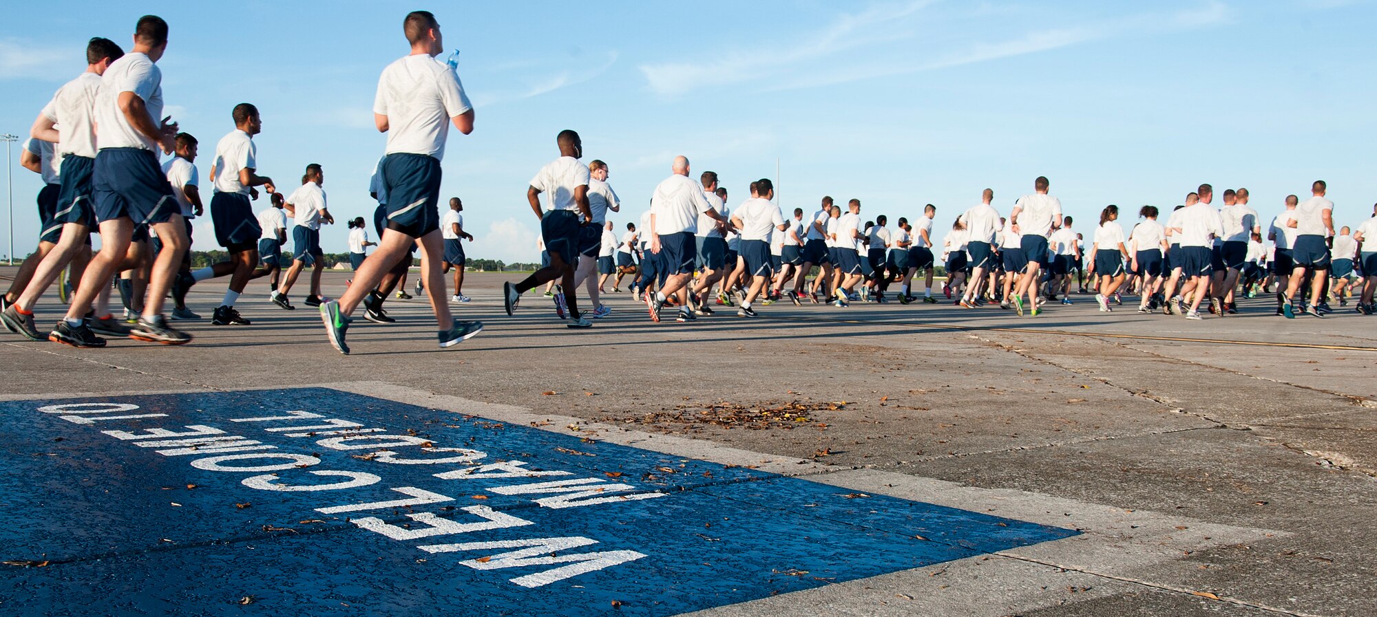 Airmen from Team MacDill participate in a flightline 5K run on Wingman Day August 17, 2015, at MacDill Air Force Base, Fla. MacDill hosts two Wingman Days throughout the year to ensure that Airmen are knowledgeable and exercising Comprehensive Airman Fitness. (U.S. Air Force photo by Senior Airman Jenay Randolph/Released)  
