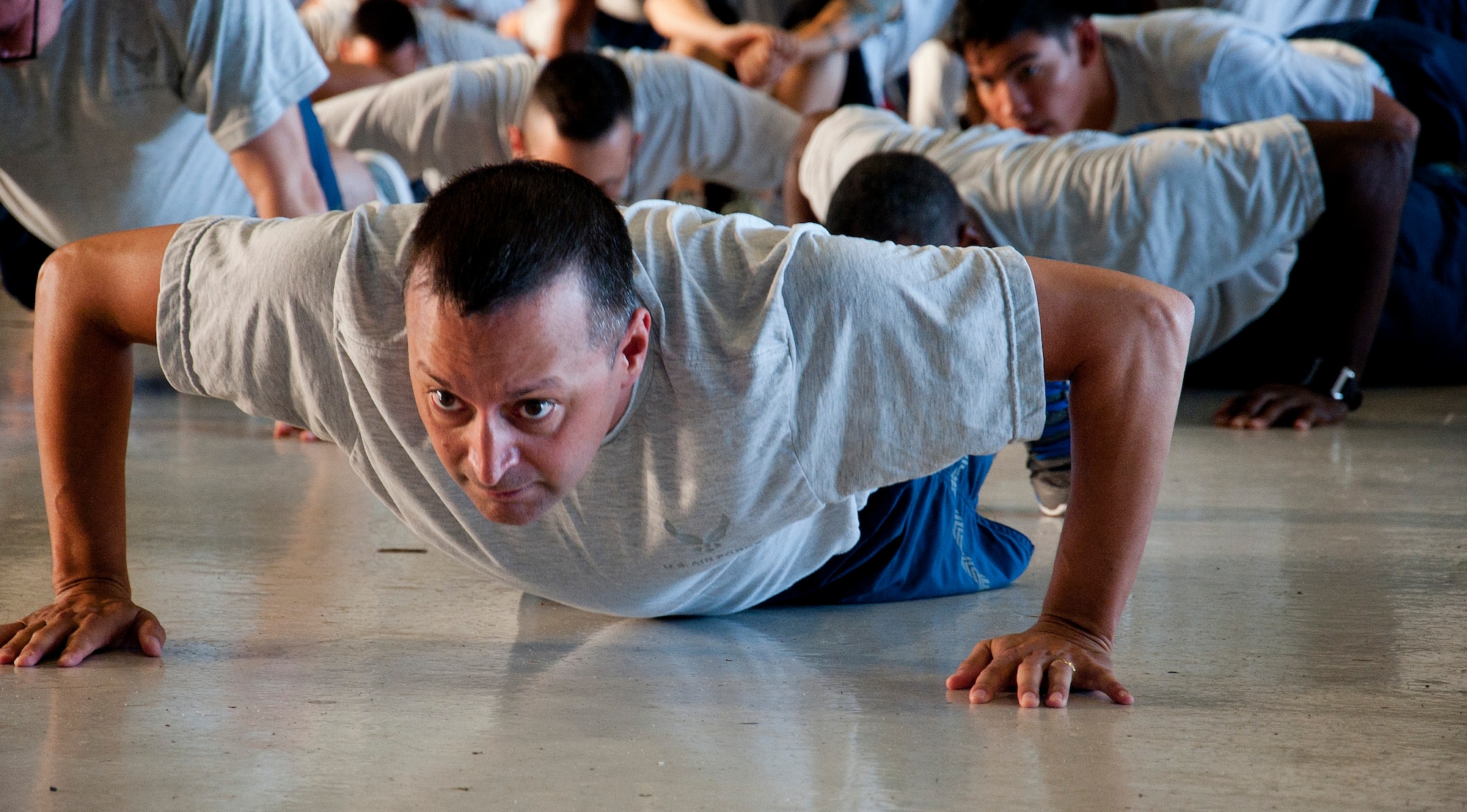 Chief Master Sgt. Michael Joseph, 6th Mission Support Group superintendent, does pushups during Wingman Day August 17, 2015, at MacDill Air Force Base, Fla. Wingman Day consisted of a flightline 5K run and small group discussions on the physical and social pillars  of Comprehensive Airman Fitness. (U.S. Air Force photo by Senior Airman Jenay Randolph/Released)   