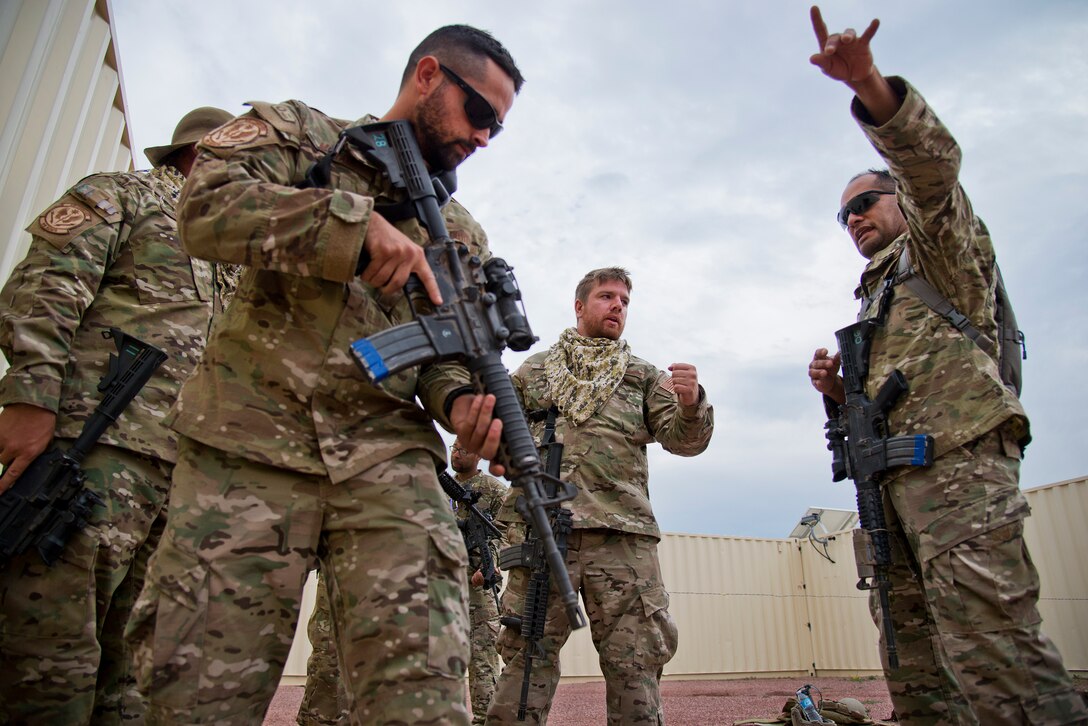 Master Sgt. Paul Morales, 919th Special Operations Security Forces Squadron, discusses building-clearing techniques with his team during the squadron’s annual training at Camp Guernsey, Wyo., Aug. 3.  More than 20 Airmen went out West to help train two other Reserve security forces squadrons in ground combat and field training.  The 919th SOSFS Airmen lived in the makeshift camps and acted as opposing forces and local villagers interacting with the occupying security teams. (U.S. Air Force photo/Tech. Sgt. Sam King)