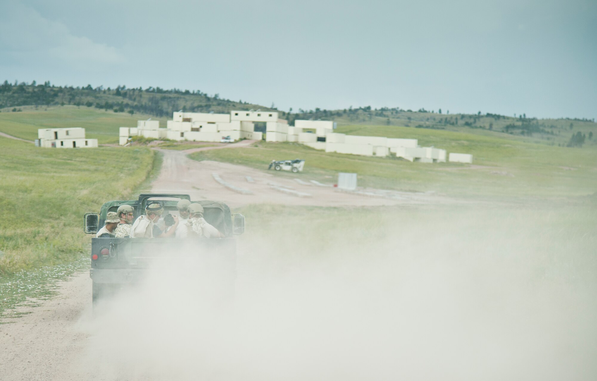 919th Special Operations Security Forces Squadron Airmen move toward their makeshift home in the back of a Humvee during the squadron’s annual training at Camp Guernsey, Wyo., Aug. 4.  More than 20 Airmen went out West to help train two other Reserve security forces squadrons in ground combat and field training.  The 919th SOSFS Airmen lived in the makeshift camps and acted as opposing forces and local villagers interacting with the occupying security teams. (U.S. Air Force photo/Tech. Sgt. Sam King)