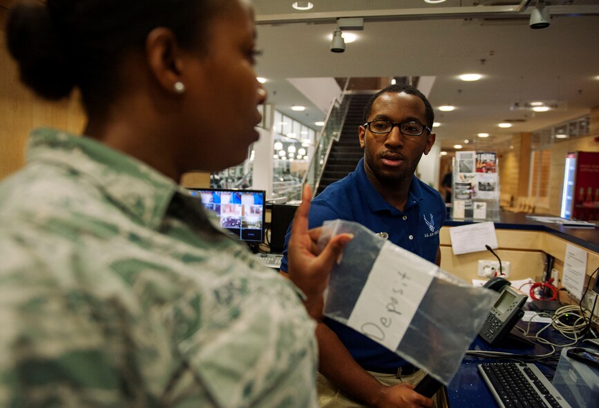 U.S. Air Force Staff Sgt. Lydia Lewis, a 52nd Force Support Squadron sports program manager, left, talks to U.S. Air Force Airman 1st Class Brandon Norman, a 52nd FSS fitness apprentice, during a swing shift at the Eifel Powerhaus on Spangdahlem Air Base, Germany, Aug. 20, 2015. Lewis, the facility’s acting sports program manager ensuring all physical fitness facilities used by base community groups are safe for use, and Norman, who ensures that the Spangdahlem fitness center is well-equipped, stocked and remains clean and functional, are the only two Airmen who worked during the Aug. 20 swing shift. (U.S. Air Force photo by Airman 1st Class Timothy Kim/Released)