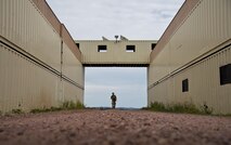 Senior Airman Amanda Smith, 919th Special Operations Security Forces Squadron, walks through the entry way of her two-week home during the squadron’s annual training at Camp Guernsey, Wyo., Aug. 3.  More than 20 Airmen went out West to help train two other Reserve security forces squadrons in ground combat and field training.  The 919th SOSFS Airmen lived in the makeshift camps and acted as opposing forces and local villagers interacting with the occupying security teams. (U.S. Air Force photo/Tech. Sgt. Sam King)
