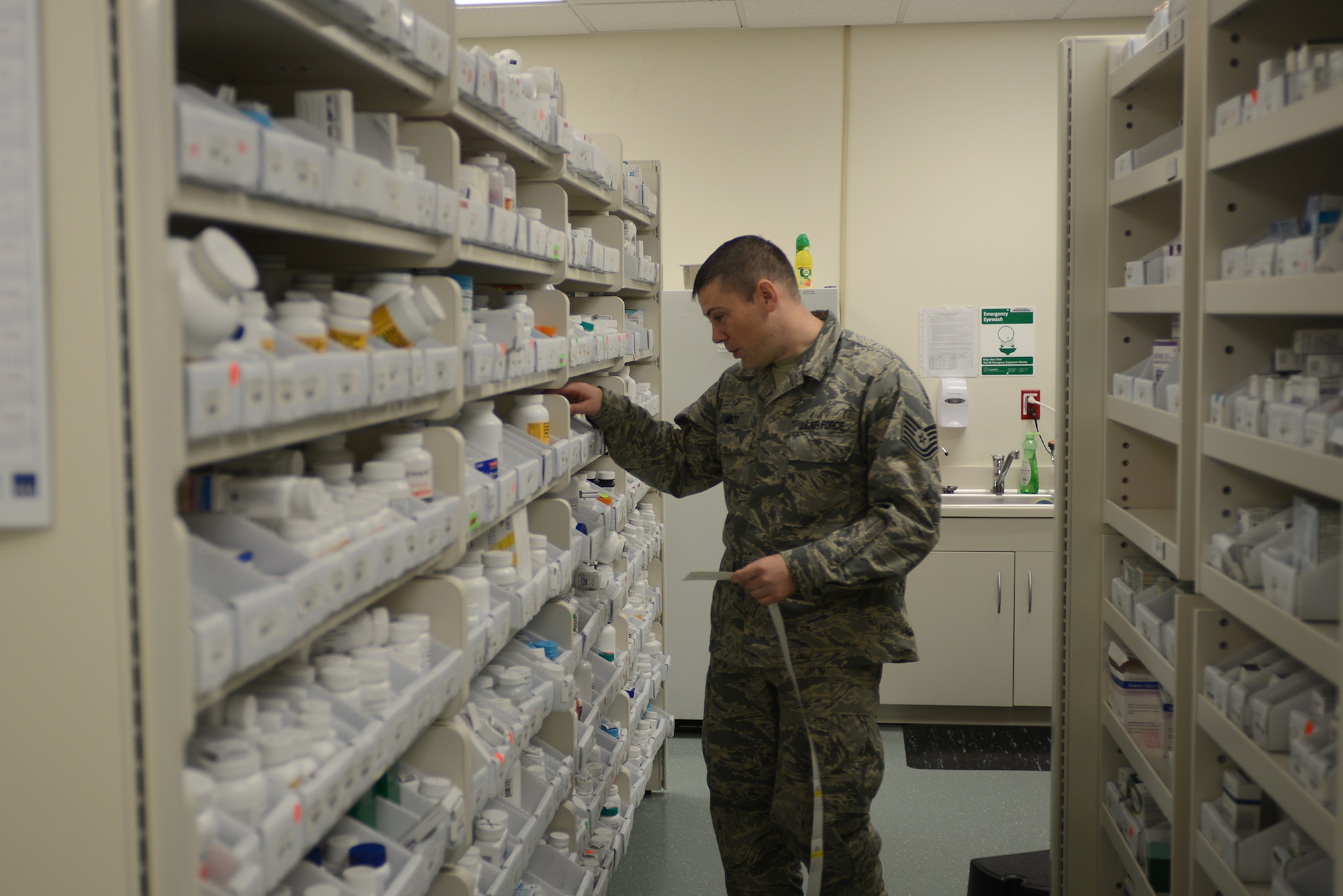 Tech. Sgt. Matthew Amiot, 374th Medical Support Squadron pharmacy technician, collects medication from a shelf at Yokota Air Base, Japan, Aug. 20, 2015. The pharmacy houses more than 1,000 medications including eye drops, creams, ointments and insulin. (U.S. Air Force photo by Senior Airman David C. Danford/Released)
