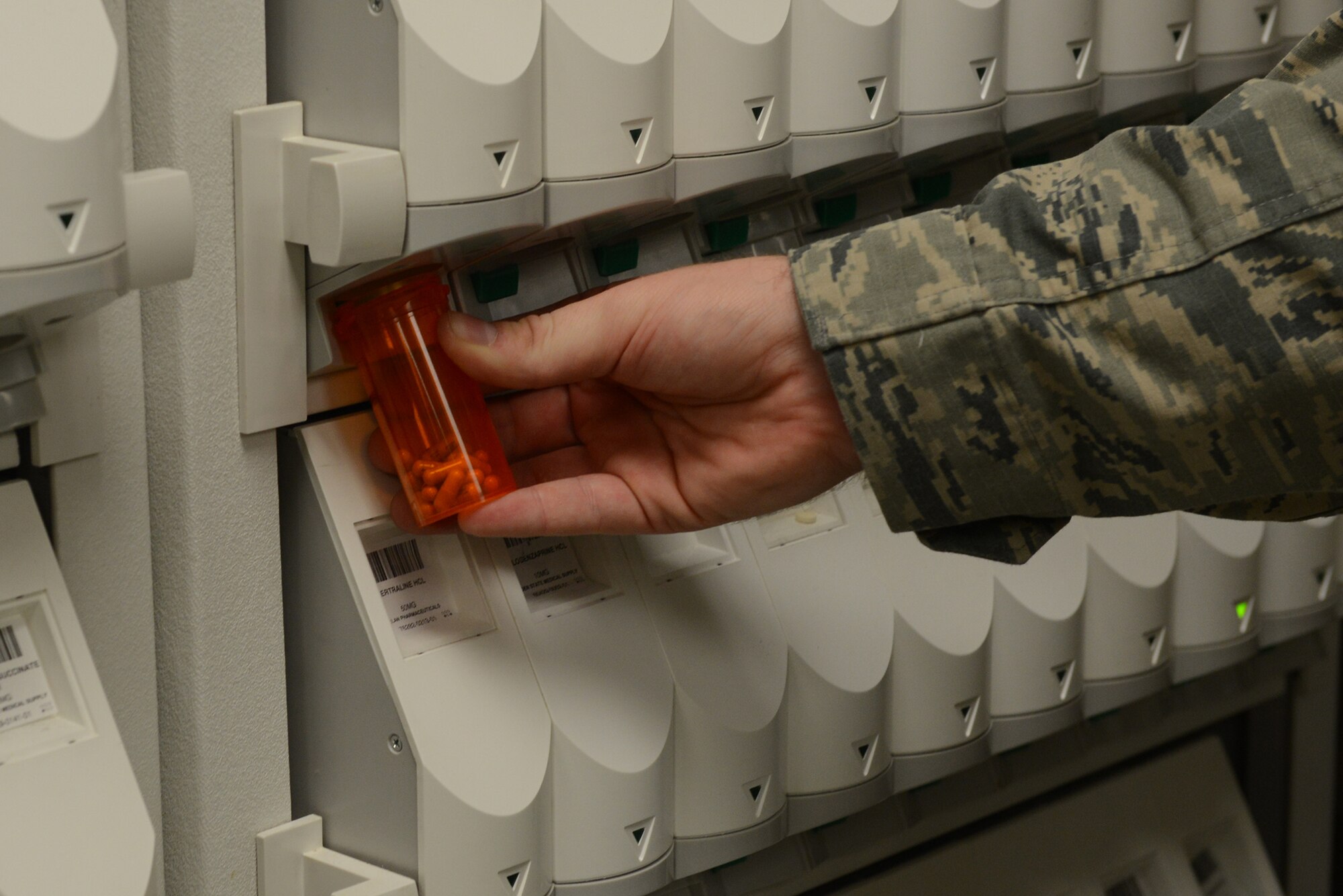 Tech. Sgt. Matthew Amiot, 374th Medical Support Squadron pharmacy technician, uses the pharmASSIST dispensing system to fill a prescription at Yokota Air Base, Japan, Aug. 20, 2015. The pharmASSIST program makes the process of filling commonly used medications easier. (U.S. Air Force photo by Senior Airman David C. Danford/Released)