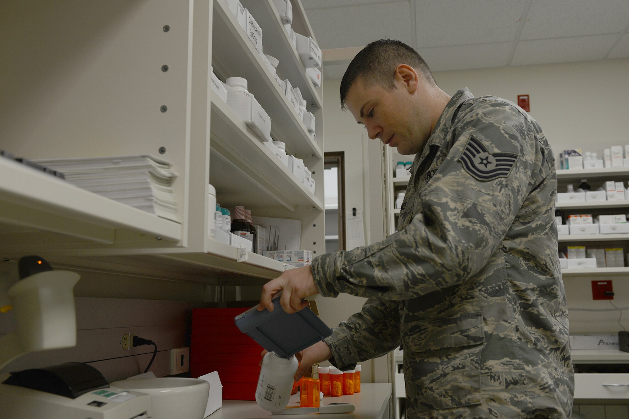 Tech. Sgt. Matthew Amiot, 374th Medical Support Squadron pharmacy technician, fills a bottle with prescription tablets at Yokota Air Base, Japan, Aug. 20, 2015. The pharmacy houses more than 1,000 medications including eye drops, creams, ointments and insulin. (U.S. Air Force photo by Senior Airman David C. Danford/Released)