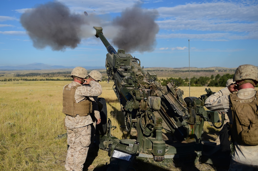 Marines from Quebec Battery, 5th Battalion 14 Marines, fire a round out of a M777 A2 Howitzer during a training exercise Aug. 15, 2015, in Guernsey, Wyoming. Q Battery, a Marine reserve artillery battery, conducted a live-fire exercise for four days to gain proficiency in their craft. (U.S. Air Force photo by Airman 1st Class Luke W. Nowakowski/Released)