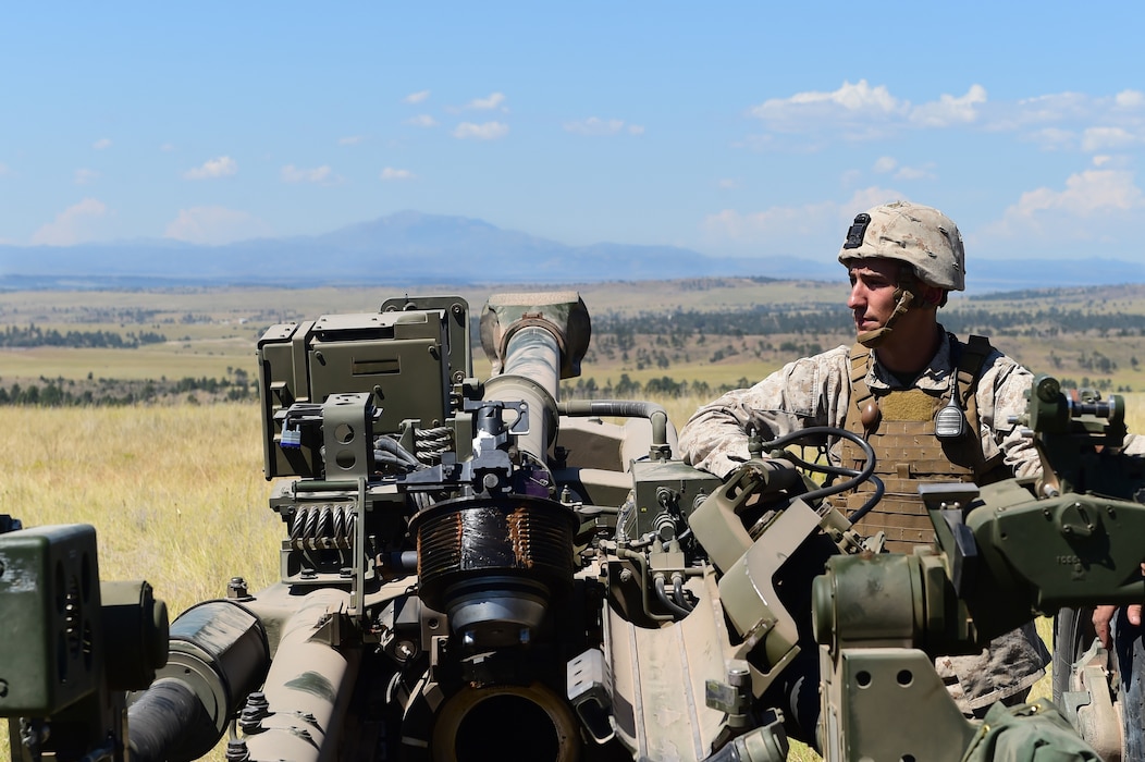 Lance Cpl. Daniil Kravchuk, Quebec Battery towed artillery systems technician, stands awaiting a fire mission Aug. 15, 2015, in Guernsey, Wyoming. Kravchuk, an active duty Marine, brings experience and knowledge to the reserve battery due to his experience as a ‘gun doc’ in the Fleet. (U.S. Air Force photo by Airman 1st Class Luke W. Nowakowski/Released)