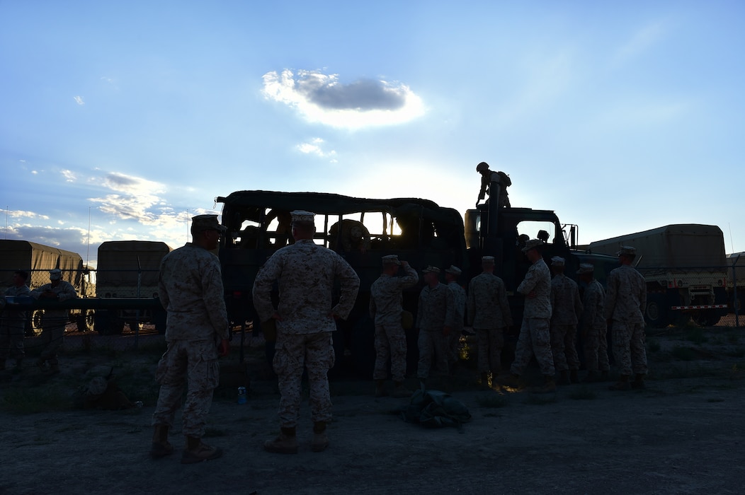 Marines from Quebec Battery, 5th Battalion 14 Marines, unload equipment Aug. 13, 2015, at Camp Guernsey, Wyoming. Quebec Battery Marines, a reserve unit that stage out of Buckley AFB, readied equipment the night before they hit the countryside for a three-day live fire exercise. The unit completes live fire exercises during the year to stay proficient at their craft. (U.S. Air Force photo by Airman 1st Class Luke W. Nowakowski/Released)