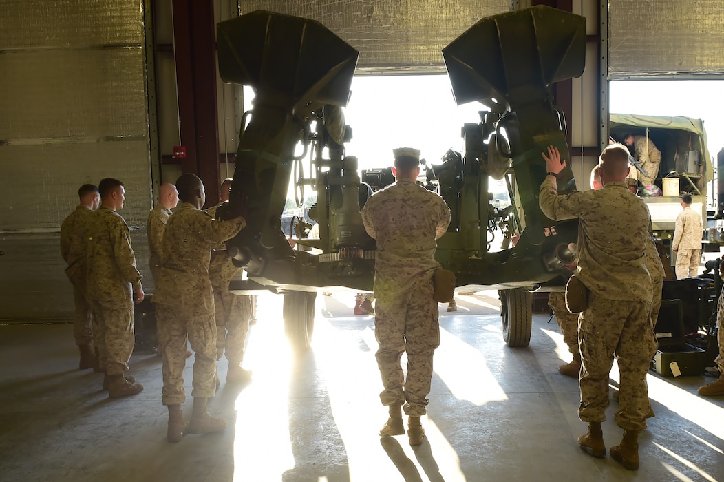 Marines from Quebec Battery, 5th Battalion 14 Marines, push a M777 A2 Howitzer toward an awaiting truck to be hauled up to Camp Guernsey, Wyoming, Aug. 13, 2015, on Buckley Air Force Base, Colo. Q Battery is a Marine reserve unit that stages out Buckley AFB and conducted a three-day live fire exercise in Guernsey, Wyoming. (U.S. Air Force photo by Airman 1st Class Luke W. Nowakowski/Released)