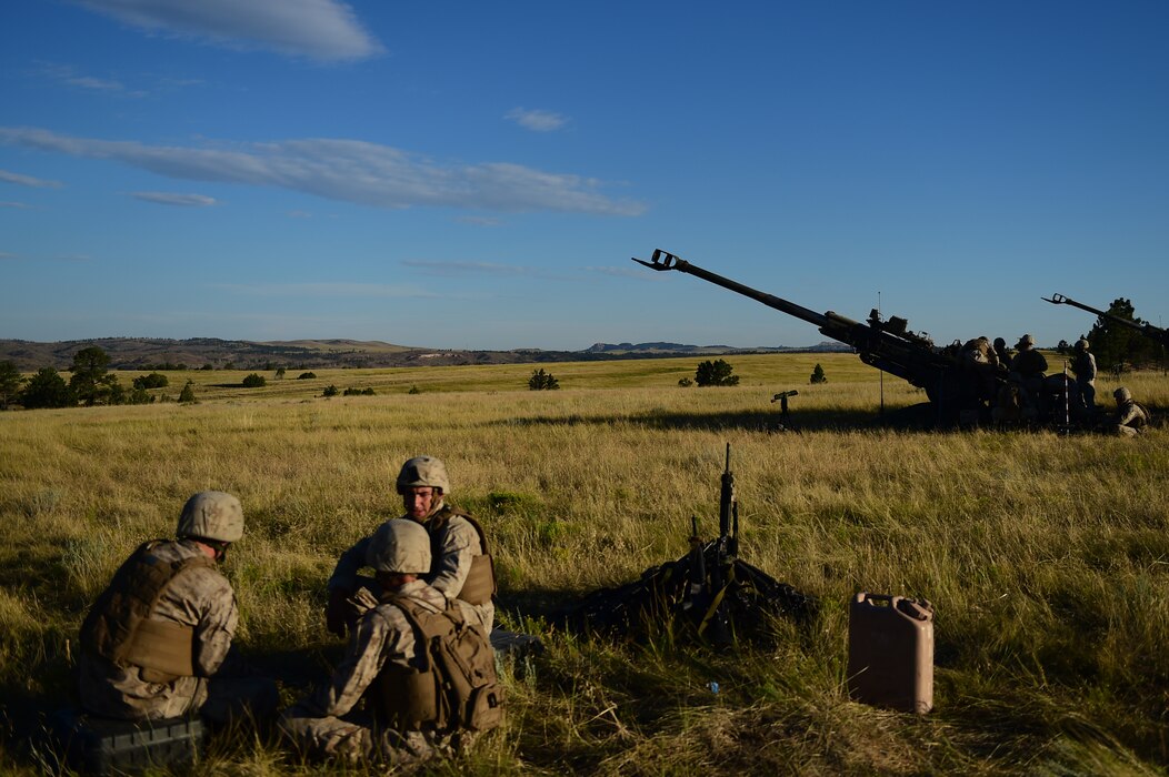 Marines from Quebec Battery, 5th Battalion 14 Marines, wait for a fire mission Aug. 15, 2015, in Guernsey, Wyoming. Q Battery, a Marine reserve artillery battery, conducted a live-fire exercise for four days to gain proficiency in their craft. (U.S. Air Force photo by Airman 1st Class Luke W. Nowakowski/Released)
