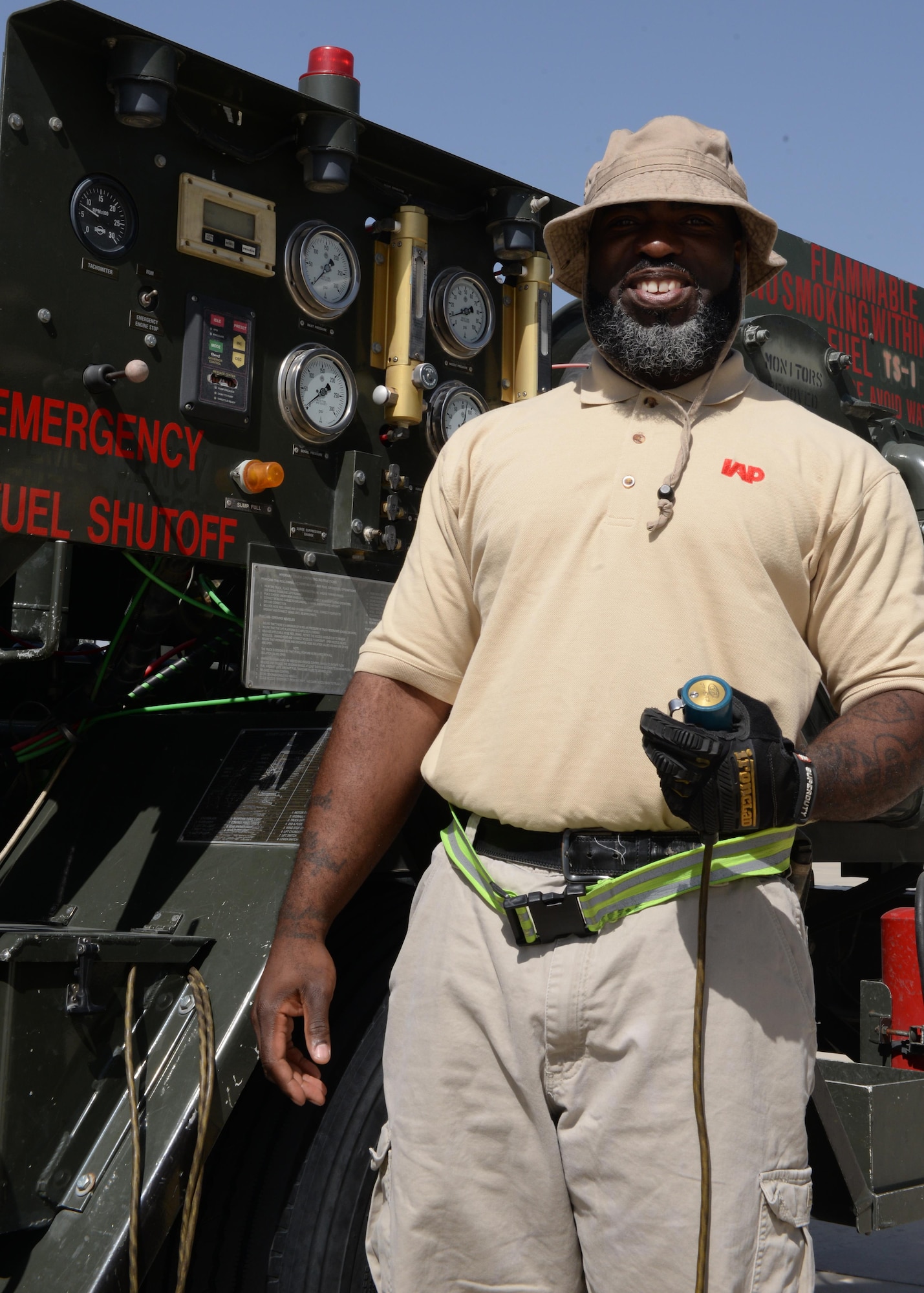 John Jackson, 455th Logistics Readiness Squadron fuels technician, poses for a photo before fueling an aircraft Aug. 22, 2015, at Bagram Airfield, Afghanistan. Jackson is a contractor with the Ingenuity and Purpose contracting company and is responsible for fueling all aircraft that come to and from Bagram. (U.S. Air Force photo by Senior Airman Cierra Presentado/Released)