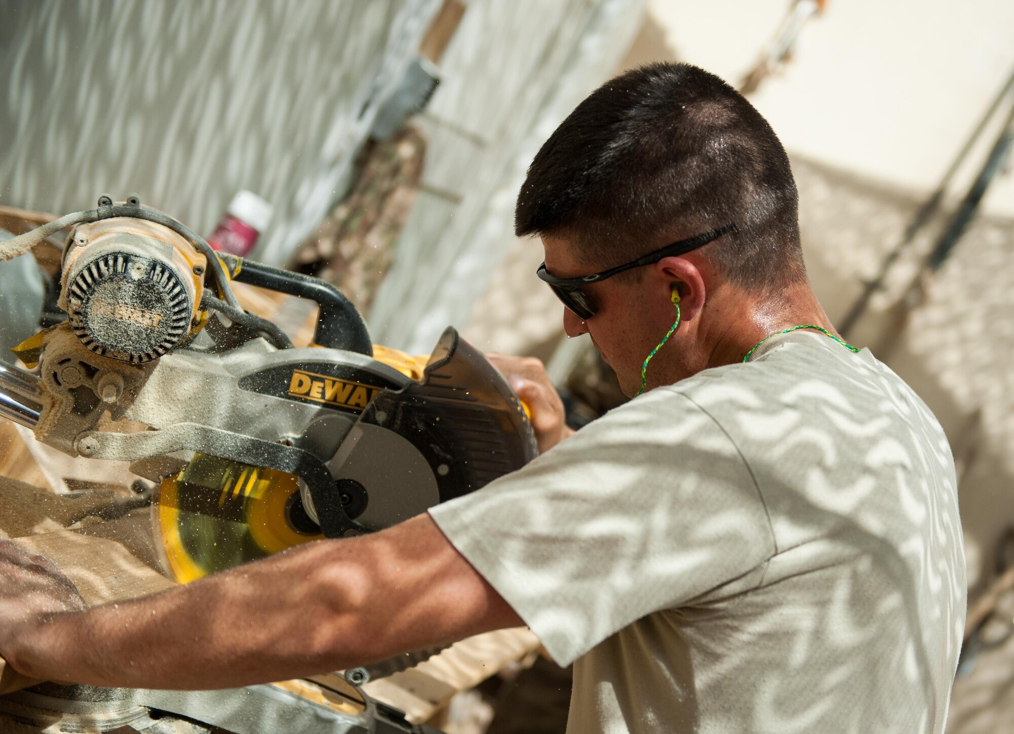 U.S. Air Force Tech. Sgt. Dallan Livingston, 451st Expeditionary Support Squadron Central Command Material Recovery Element air transportation specialist, builds a set of stairs for a defensive fighting position at Kandahar Airfield, Afghanistan, Aug. 15, 2015.  Livingston has been using his carpentry skills during his spare time to build projects to better KAF. (U.S. Air Force photo by Tech. Sgt. Joseph Swafford/Released)