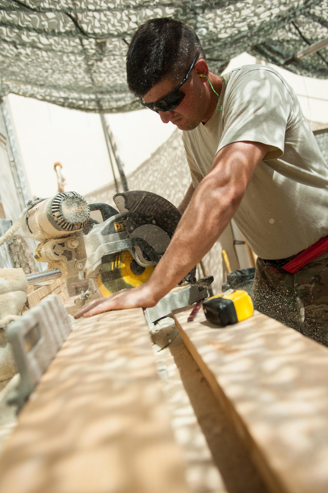 U.S. Air Force Tech. Sgt. Dallan Livingston, 451st Expeditionary Support Squadron Central Command Material Recovery Element air transportation specialist, builds a set of stairs for a defensive fighting position at Kandahar Airfield, Afghanistan, Aug. 15, 2015.  Livingston has been using his carpentry skills during his spare time to build projects to better KAF. (U.S. Air Force photo by Tech. Sgt. Joseph Swafford/Released)