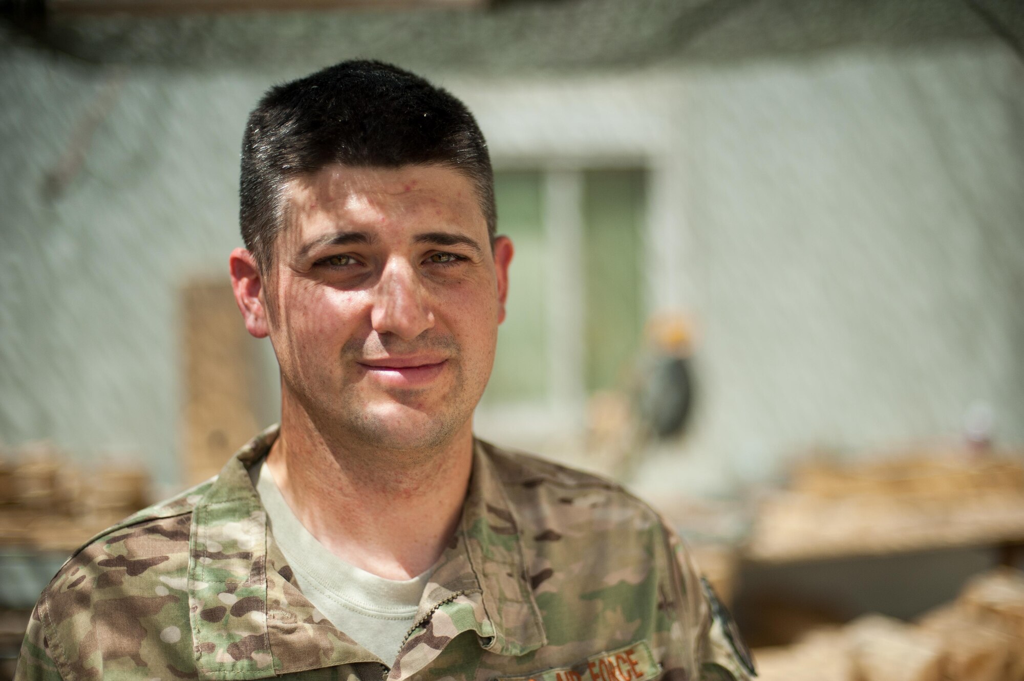 U.S. Air Force Tech. Sgt. Dallan Livingston, 451st Expeditionary Support Squadron Central Command Material Recovery Element air transportation specialist, poses for a photo after building a set of stairs for a defensive fighting position at Kandahar Airfield, Afghanistan, Aug. 15, 2015.  Livingston has been using his carpentry skills during his spare time to build projects to better KAF. (U.S. Air Force photo by Tech. Sgt. Joseph Swafford/Released)