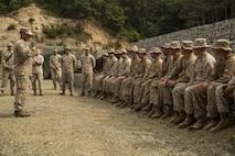 Brig. Gen. Tracy King, left, speaks to Marines participating in Korean Military Exchange Program 15-9 at Rodriguez Live-Fire Complex, Republic of Korea, June 25, 2015. King spoke to the Marines about the importance of training with their allies in the Republic of Korea, as well as the significance and strategic value Okinawa provides the III Marine Expeditionary Force. KMEP 15-9 is focused on improving 9th Engineer Support Battalion’s engineering capabilities while enhancing relations across the Korean Peninsula. King is the 3rd Marine Logistics Group commanding general. (U.S. Marine Corps photo by Cpl. Joey S. Holeman, Jr./ Released)