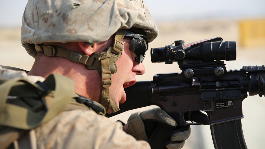 A security force Marine with Marine Wing Support Squadron-371, Special Purpose Marine Air-Ground Task Force -Crisis Response-Central Command shouts a command while providing cover for his partner during live-fire combat maneuver range in Southwest Asia, August 19, 2015. The live-fire range is designed to emulate realistic combat conditions and force Marines to shoot, move, and communicate to overcome targets at an unknown distance.