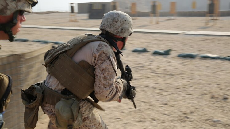 U.S. Marines with Marine Wing Support Squadron-371, Special Purpose Marine Air-Ground Task Force--Crisis Response--Central Command bound to their next target during live-fire, combat maneuver range in Southwest Asia, August 19, 2015. The live-fire range is designed to emulate realistic combat conditions and force Marines to shoot, move, and communicate to overcome targets at an unknown distance. 