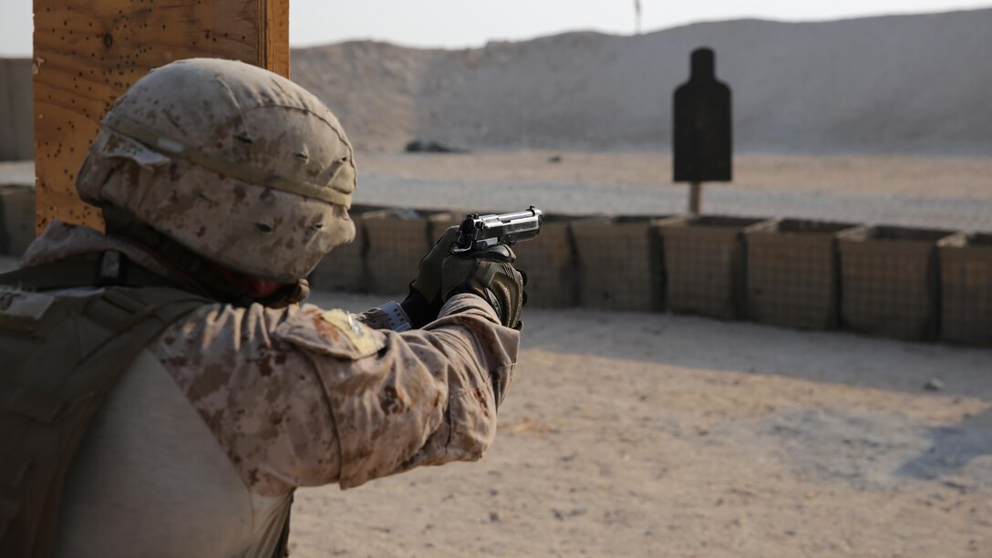 A security forces Marine with Marine Wing Support Squadron-371, Special Purpose Marine Air-Ground Task Force--Crisis Response--Central Command fires after transitioning to his pistol during a live-fire, combat maneuver range in Southwest Asia, August 19, 2015. The live-fire range is designed to emulate realistic combat conditions and force Marines to shoot, move, and communicate to overcome targets at an unknown distance. 