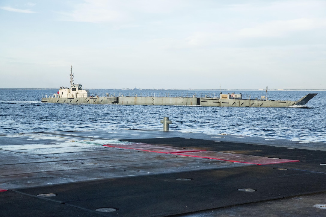 An Improved Navy Lighterage System coasts by a Roll-on/Roll-off Discharge Facility during a Marine Prepositioning Force Exercise, Aug. 19, 2015. Marines with Combat Logistics Regiment 25 and sailors with Naval Beach Group 2 joined forces for the latest iteration of MPFEX, which saw service members offloading the Lummus using Lift-on/Lift-Off and Roll-on/Roll-off procedures off the coat of Marine Corps Support Facility Blount Island, Fla. (U.S. Marine Corps photo by Sgt. Shawn Valosin/Released)