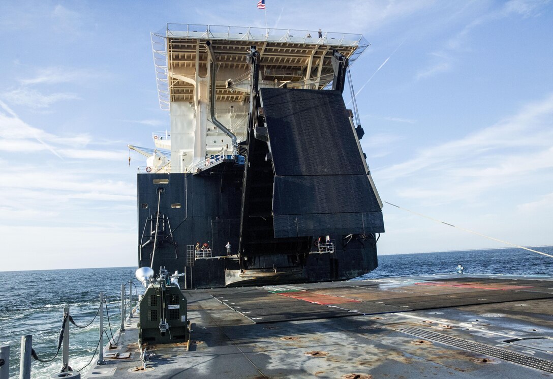 A ramp is lowered from the USNS 1st Lt. Jack Lummus to a Roll-on/Roll-off Discharge Facility (RRDF), during an in-stream Marine Prepositioning Force Exercise, Aug. 19, 2015. The ramp allowed Marines with Combat Logistics Regiment 25 to drive equipment off the Lummus onto the RRDF and Improved Navy Lighterage Systems, where it was then transferred to Marine Corps Support Facility Blount Island, Fla. (U.S. Marine Corps photo by Sgt. Shawn Valosin/Released)