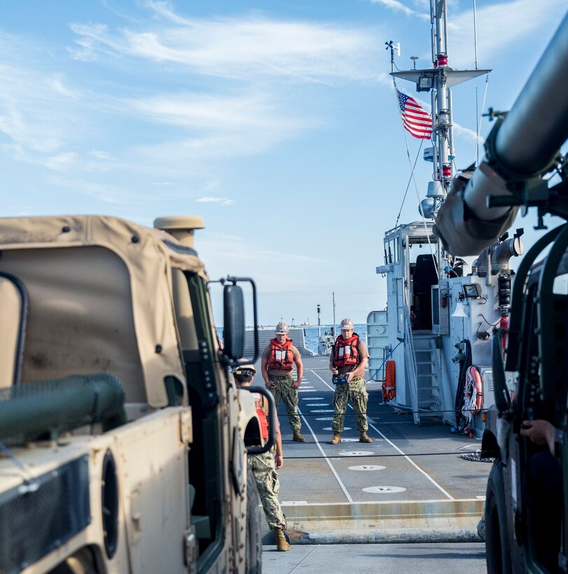 A sailor attached to Naval Beach Group 2 uses a joystick to steer an Improved Navy Lighterage System into position with a Roll-on/Roll-off Discharge Facility  during a Marine Prepositioning Force Exercise, Aug. 19, 2015. Marines with Combat Logistics Regiment 25 and sailors with NBG- 2 joined forces for the latest iteration of MPFEX, which saw service members offloading the USNS 1st Lt. Jack Lummus using Lift-on/Lift-Off and Roll-on/Roll-off procedures off the coat of Marine Corps Support Facility Blount Island, Fla. (U.S. Marine Corps photo by Sgt. Shawn Valosin/Released)