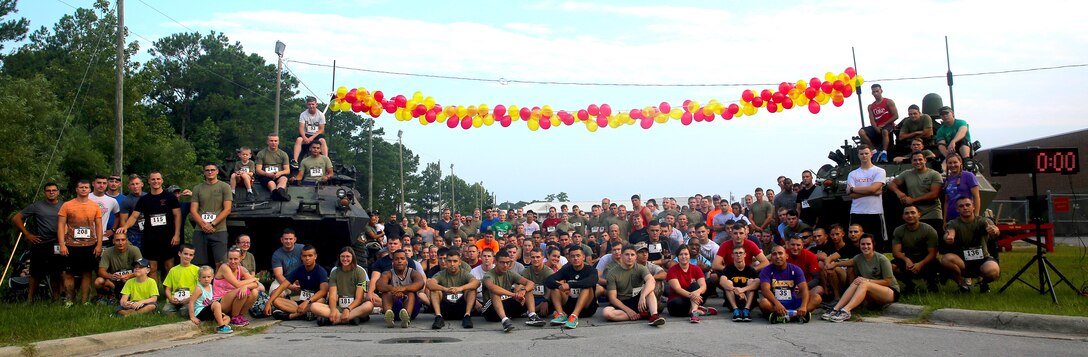 Marines from 2nd Radio Battalion gather for a photo before a memorial run in honor of Sgt. Lucas Pyeatt aboard Camp Lejeune, N.C., Aug. 1, 2015. The annual run has been hosted by the battalion for three years and commemorates Pyeatt and other fallen service members.  (U.S. Marine Corps photo by Pfc. Erick Galera/Released)