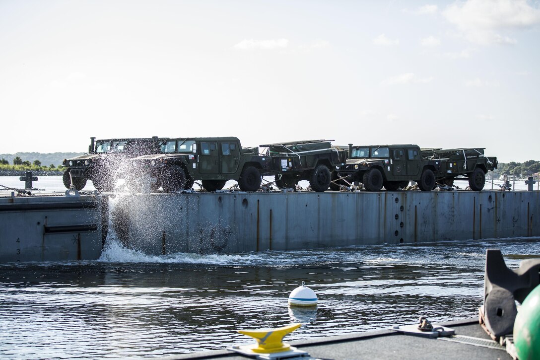 An Improved Navy Lighterage System loaded with vehicles from a recent Marine Expeditionary Unit coasts into the shoreline during a Marine Prepositioning Force Exercise aboard Marine Corps Support Facility Blount Island, Fla., Aug. 10, 2015. Marines with Combat Logistics Regiment 25 teamed up with sailors from Naval Beach Group-2 for the latest iteration of the MPFEX. (U.S. Marine Corps photo by Sgt. Shawn Valosin/Released)