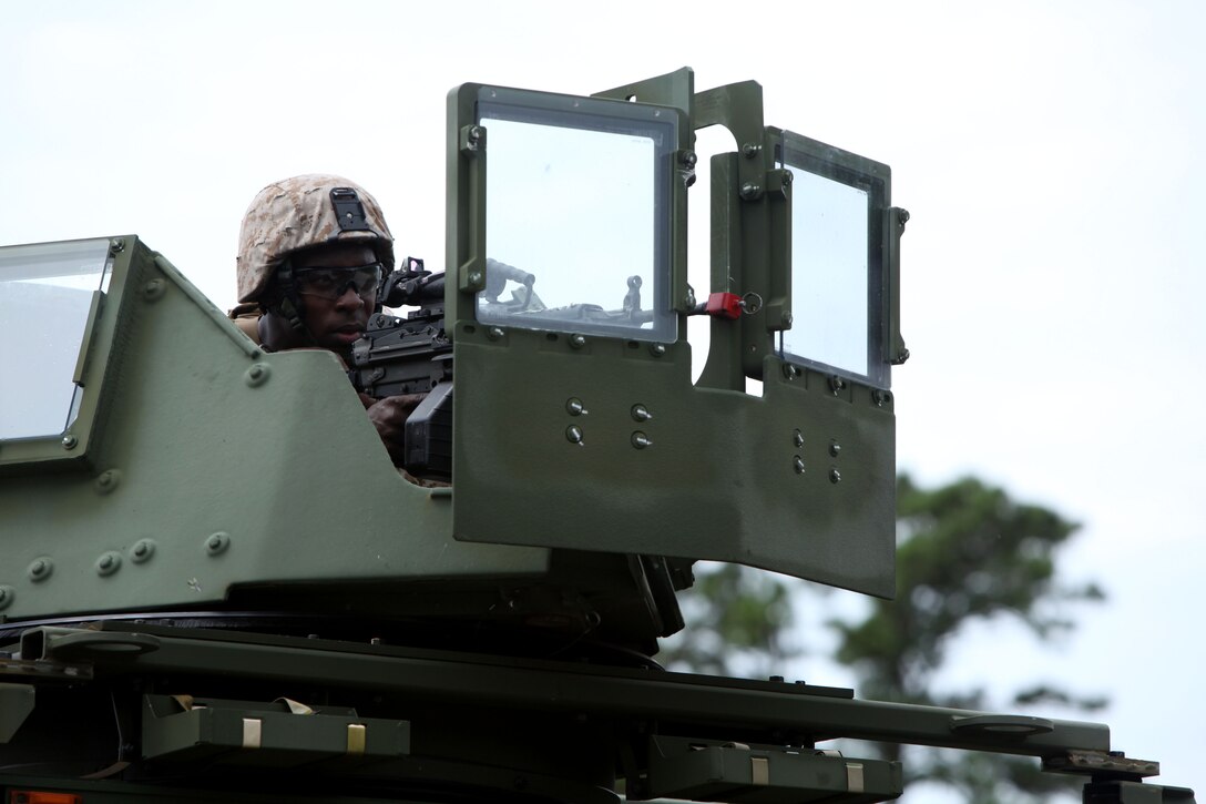 Pfc. Daris Hodge stands post atop a crew-served weapon during an airbase ground defense field operation at Marine Corps Auxiliary Landing Field Bogue, North Carolina, Aug. 19, 2015. Nearly 300 Marines with Marine Wing Support Squadron 271were involved in the field operation by providing security for ground operations during portrayed enemy attacks. Lark is an aircraft rescue and firefighting specialist with MWSS-271. Hodge is a bulk fuel specialist with MWSS-271.