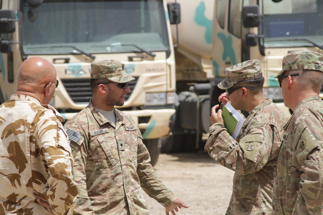 U.S. Army Spc. Rahdi Mortda (middle left), a military linguist attached to the 310th Logistics Advise and Assist Team, interprets for a leader engagement between the 310th A & A and Iraqi security forces at Camp Taji, Iraq, Aug. 8, 2015. Army linguists are a vital part of the logistics advise and assist mission in support of Operation Inherent Resolve. 
Photo by Capt. A. Sean Taylor, 310th A&A