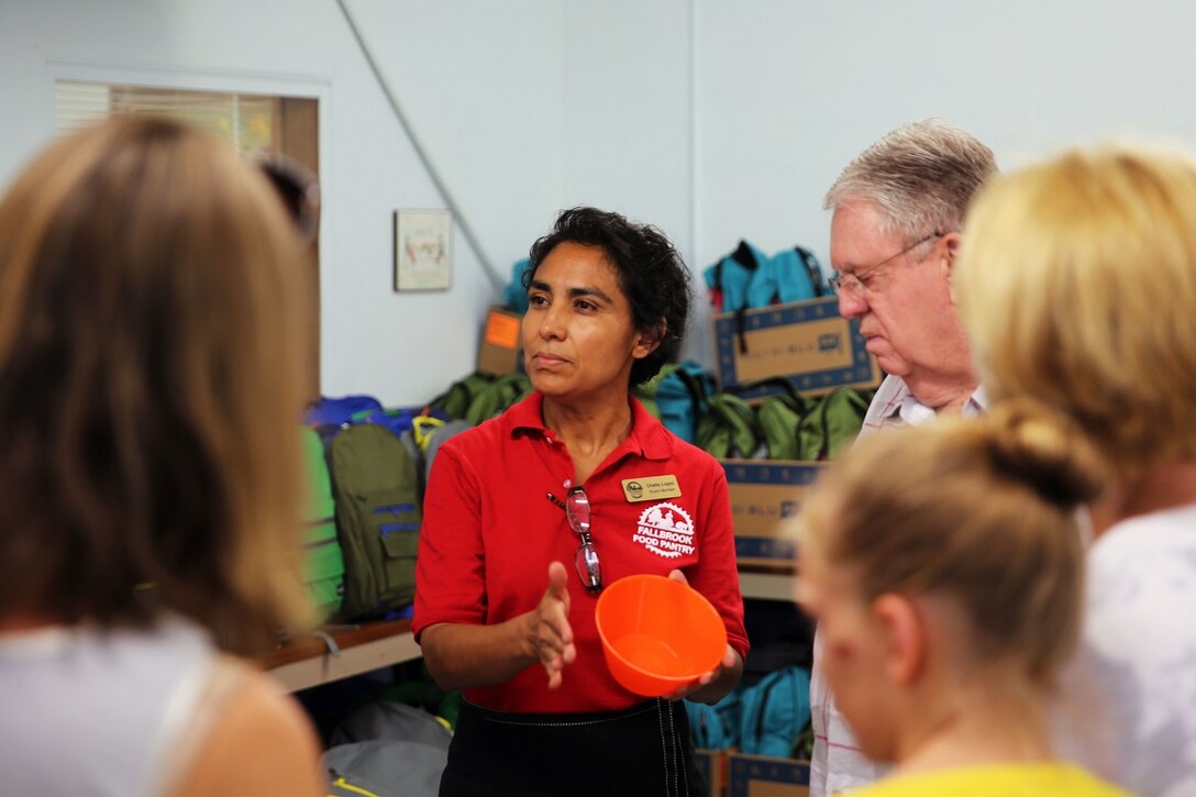 Onelia Lopez, a Huehuetenango, Guatemala, native, and a board member with the Fallbrook Food Pantry in Fallbrook, Calif., briefs volunteers before a backpack drive on Aug. 15, 2015. The Fallbrook Food Pantry collects food donations, school supplies and backpacks from local businesses and redistributes them to families going through difficult times. (USMC photo by Pfc. Devan K. Gowans/Released)