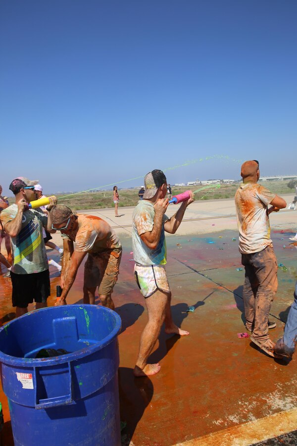 Marines spray color gel at participants during the Color Me Rad 5k San Diego aboard Marine Corps Air Station Miramar, California, Aug. 22. Marines and Sailors aboard MCAS Miramar volunteered for the event. (U.S. Marine photo by Lance Cpl. Kimberlyn Adams/Released)