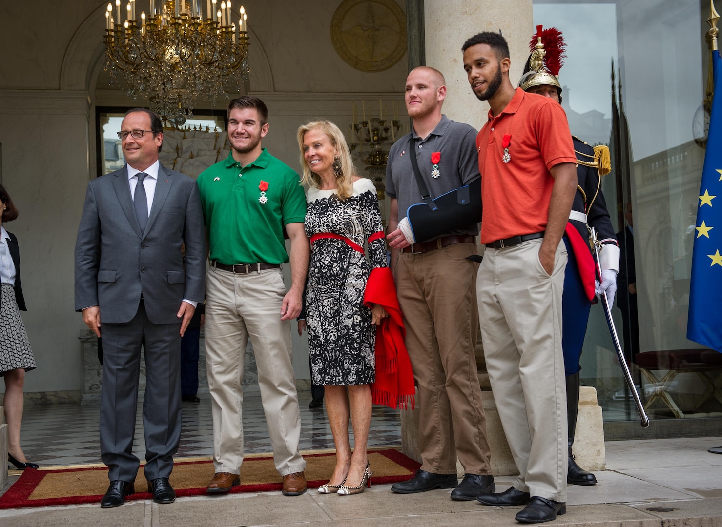 Spc. Alek Skarlatos, green shirt, with the Oregon Army National Guard’s 41st Infantry Brigade Combat Team, stands with French President François Hollande, left, Jane Hartley, U.S. ambassador to France, and friends Air Force Airman 1st Class Spencer Stone, with cast, and Anthony Sadler after a ceremony Monday at the Élysée in Paris where they received the Legion of Honor, France’s highest award, for their actions in subduing an attacker on a Paris-bound train armed with an assault rifle and other weapons. The three friends, with the help of a British passenger, tackled and subdued the gunman when he stopped to reload after opening fire in an adjacent car. (U.S. Air Force photo/Tech. Sgt. Ryan Crane)