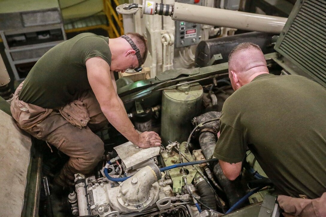 GULF OF ADEN (Aug. 21, 2015) U.S. Marine Sgt. Alex Snyder, right, and Gunnery Sgt. Vincent Rafferty tune the engine and check for proper gaps on a Light Armored Vehicle (LAV-25) in the well deck aboard the amphibious transport dock ship USS Anchorage (LPD 23). Snyder is the ramp chief and Rafferty is the maintenance chief with Diablo Company, Light Armored Reconnaissance Detachment, Battalion Landing Team 3rd Battalion, 1st Marine Regiment, 15th Marine Expeditionary Unit (MEU).  Elements of the 15th MEU are embarked aboard the amphibious transport dock ship USS Anchorage (LPD 23), part of the Essex Amphibious Ready Group, and are deployed in support of maritime security operations and theater security cooperation efforts in the U.S. 5th Fleet area of operations.  (U.S. Marine Corps photo by Sgt. Steve H. Lopez/Released)