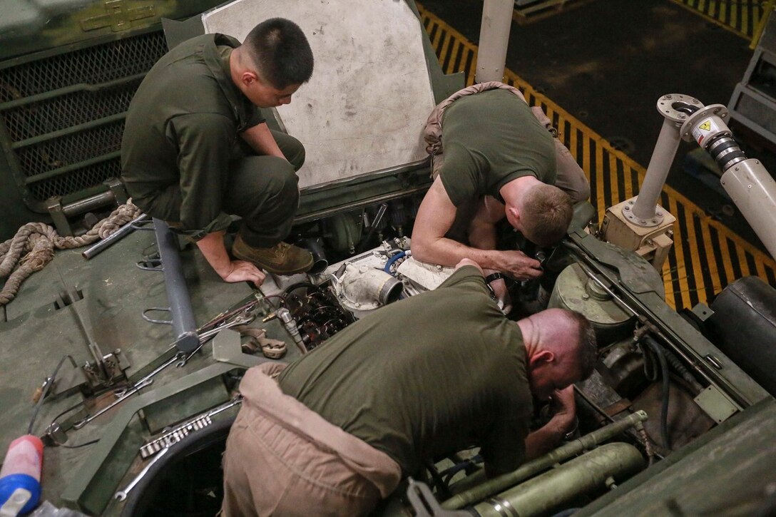 GULF OF ADEN (Aug. 21, 2015) U.S. Marines with Light Armored Reconnaissance Detachment, Battalion Landing Team 3rd Battalion, 1st Marine Regiment, 15th Marine Expeditionary Unit (MEU), tune the engine and check for proper gaps on a Light Armored Vehicle (LAV-25) in the well deck aboard the amphibious transport dock ship USS Anchorage (LPD 23). Elements of the 15th MEU are embarked aboard the amphibious transport dock ship USS Anchorage (LPD 23), part of the Essex Amphibious Ready Group, and are deployed in support of maritime security operations and theater security cooperation efforts in the U.S. 5th Fleet area of operations.  (U.S. Marine Corps photo by Sgt. Steve H. Lopez/Released)