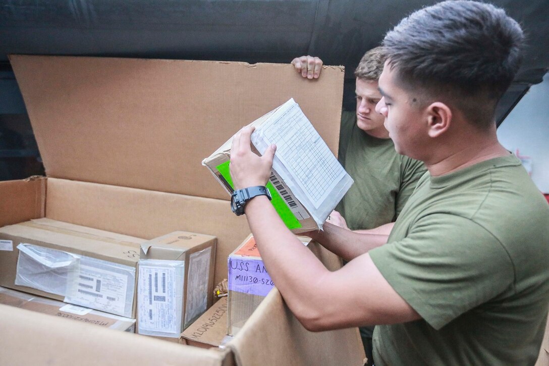 GULF OF ADEN (Aug. 22, 2015) U.S. Marine Cpl. Abner Corona sorts through supplies delivered by the USNS John Ericsson (T-AO194) to the amphibious transport dock ship USS Anchorage (LPD 23) during a replenishment-at-sea. Corona is the supply non-commissioned officer with Combat Logistics Battalion 15, 15th Marine Expeditionary Unit. Elements of the 15th MEU are embarked aboard the Anchorage, which is part of the Essex Amphibious Ready Group, and are deployed in support of maritime security operations and theater security cooperation efforts in the U.S. 5th Fleet area of operations.  (U.S. Marine Corps photo by Sgt. Steve H. Lopez/Released)