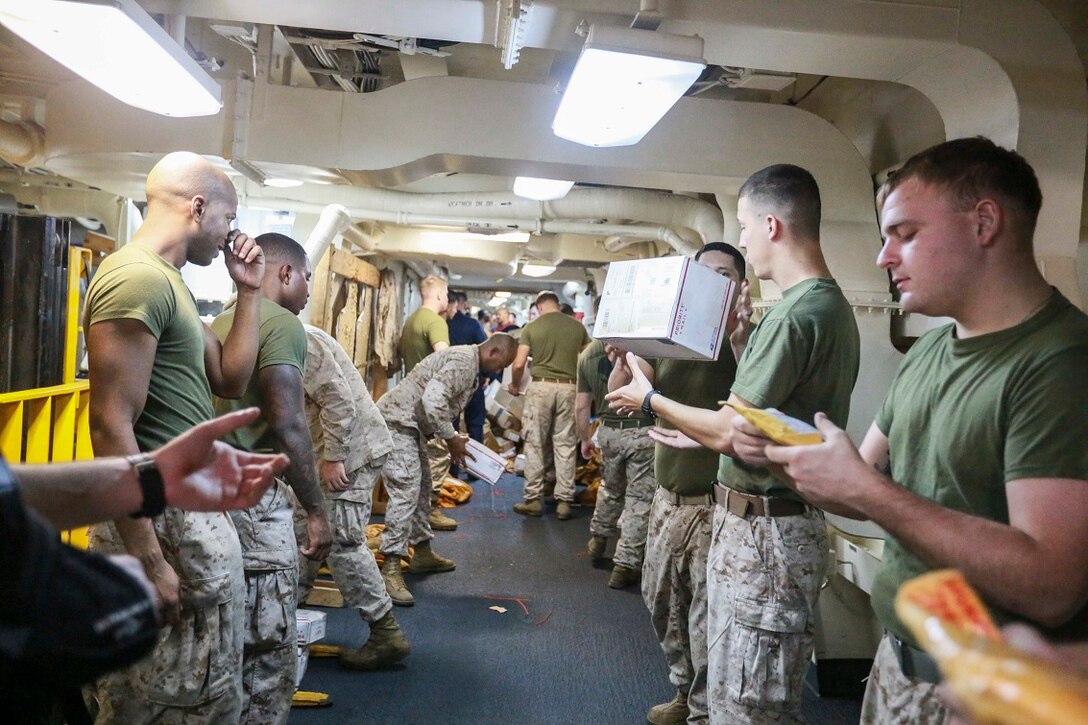 GULF OF ADEN (Aug. 22, 2015) U.S. Marines  with the 15th Marine Expeditionary Unit sort mail aboard the amphibious transport dock ship USS Anchorage (LPD 23) during a replenishment-at-sea. Elements of the 15th MEU are embarked aboard the Anchorage, which is part of the Essex Amphibious Ready Group, and are deployed in support of maritime security operations and theater security cooperation efforts in the U.S. 5th Fleet area of operations.  (U.S. Marine Corps photo by Sgt. Steve H. Lopez/Released)