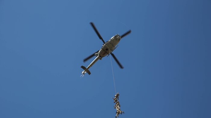 Marines from Company A, 1st Reconnaissance Battalion, 1st Marine Divison, I Marine Expeditionary Force, are suspended from a UH-1Y Huey helicopter during an exercise on Marine Corps Base Camp Pendleton, Calif., Aug. 18, 2015. Utilizing both fast-roping and Special Patrol Insertion and Extraction rigging methods, the purpose of the training exercise was to integrate operational coordination between the I MEF Ground Combat Element and Air Combat Element. 