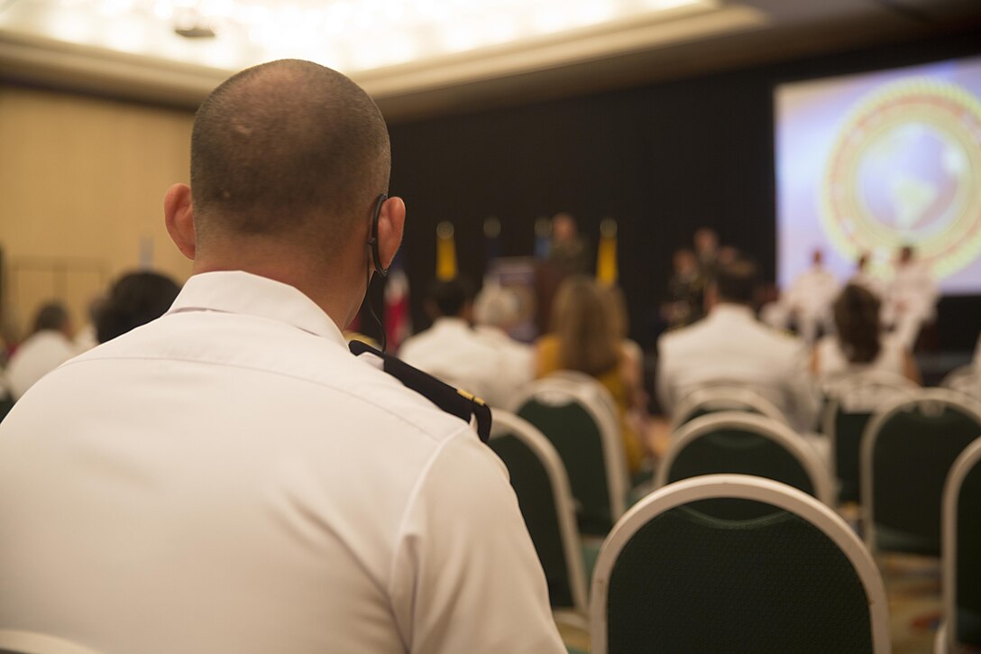 A member of the Colombian Marine Corps listens to the interpretation of Lt. Gen. Robert B. Neller’s, commanding general of U.S. Marine Corps Forces Command, speech during the opening ceremony of the Marine Leaders of the Americas Conference 2015 in Cartagena, Colombia, Aug. 24, 2015. The conference provides a forum for regional and senior naval infantry leaders throughout the Western Hemisphere to discuss shared interests in humanitarian assistance and disaster relief matters and improve training programs among partner nations. (U.S. Marine Corps photo by Sgt. Alisa J. Helin/Released)