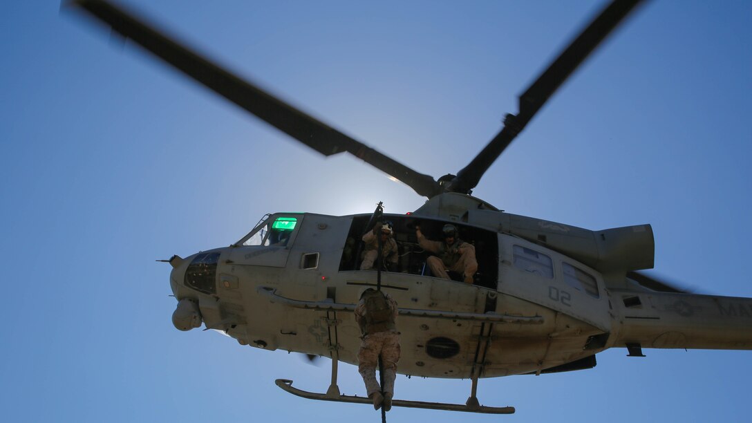 A Marine with Company A, 1st Reconnaissance Battalion, 1st Marine Division, I Marine Expeditionary Force, fast-ropes out of a UH-1Y Huey helicopter on Marine Corps Base Camp Pendleton, Calif., Aug. 18, 2015. Utilizing both fast-roping and Special Patrol Insertion and Extraction rigging methods, the purpose of the training exercise was to integrate operational coordination between the I MEF Ground Combat Element and Air Combat Element. 