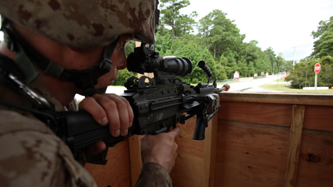 Lance Cpl. Daniel Lark sights down the entry control point during an airbase ground defense field operation at Marine Corps Auxiliary Landing Field Bogue, North Carolina, Aug. 19, 2015. Nearly 300 Marines with Marine Wing Support Squadron 271were involved in the field operation by providing security for ground operations during portrayed enemy attacks. Lark is an aircraft rescue and firefighting specialist with MWSS-271.