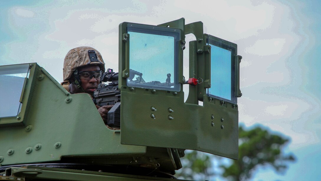 Pfc. Daris Hodge stands post atop a crew-served weapon during an airbase ground defense field operation at Marine Corps Auxiliary Landing Field Bogue, North Carolina, Aug. 19, 2015. Nearly 300 Marines with Marine Wing Support Squadron 271were involved in the field operation by providing security for ground operations during portrayed enemy attacks. Lark is an aircraft rescue and firefighting specialist with MWSS-271. Hodge is a bulk fuel specialist with MWSS-271.