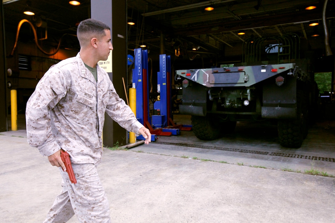 Capt. Eric Meeder role-plays as an active shooter during an anti-terrorism force protection program training event at Marine Corps Air Station Cherry Point, North Carolina, Aug. 20, 2015. Marine Air Control Group 28 Headquarters and Marine Tactical Air Command Squadron 28 conducted the drill to evaluate their current ATEP procedures. Meeder is the anti-terrorism force protection officer for MTACS-28. (U.S. Marine Corps photo by Pfc. Nicholas P. Baird/ released)